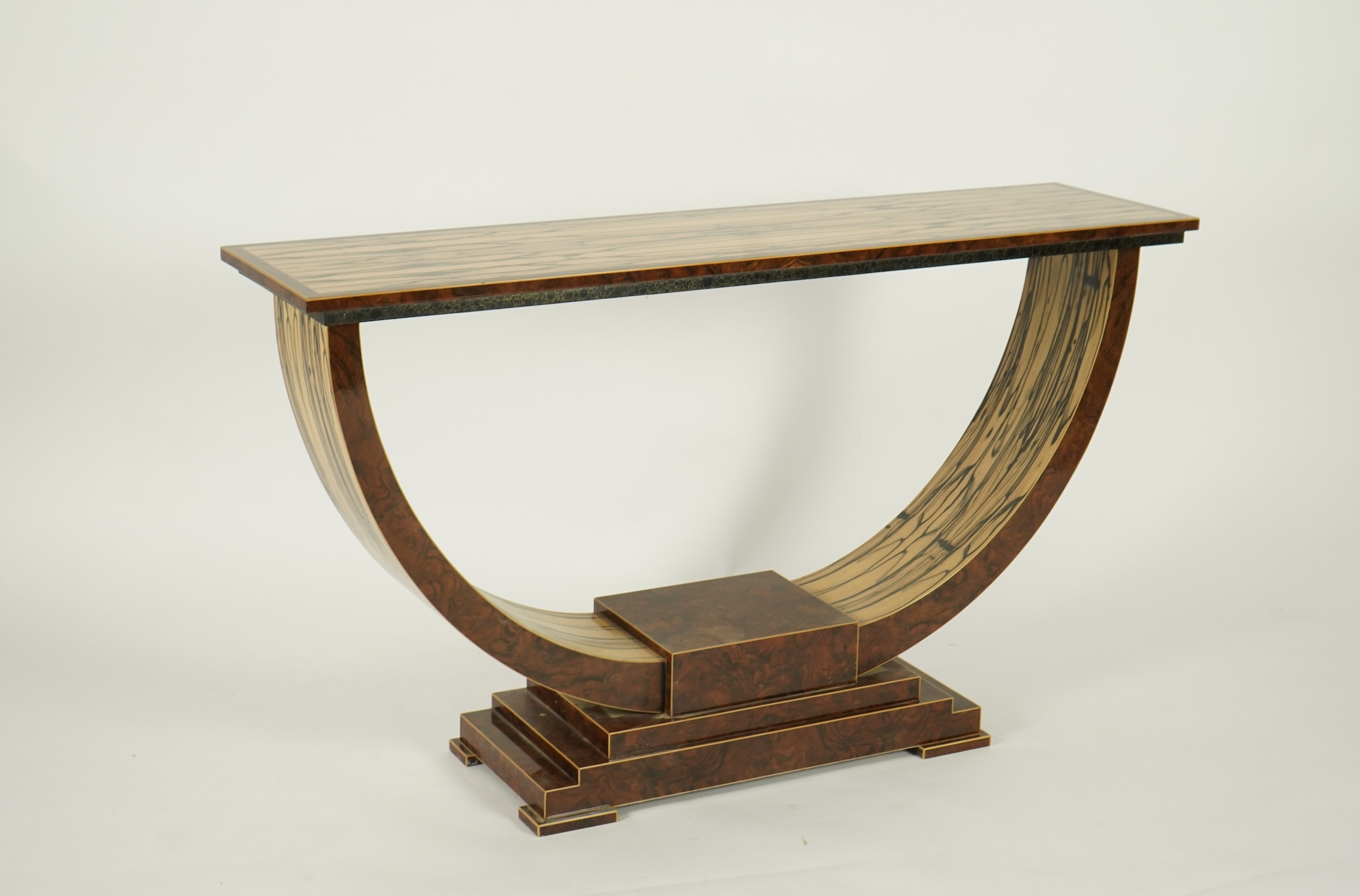 An Art Deco style white ebony and walnut console table